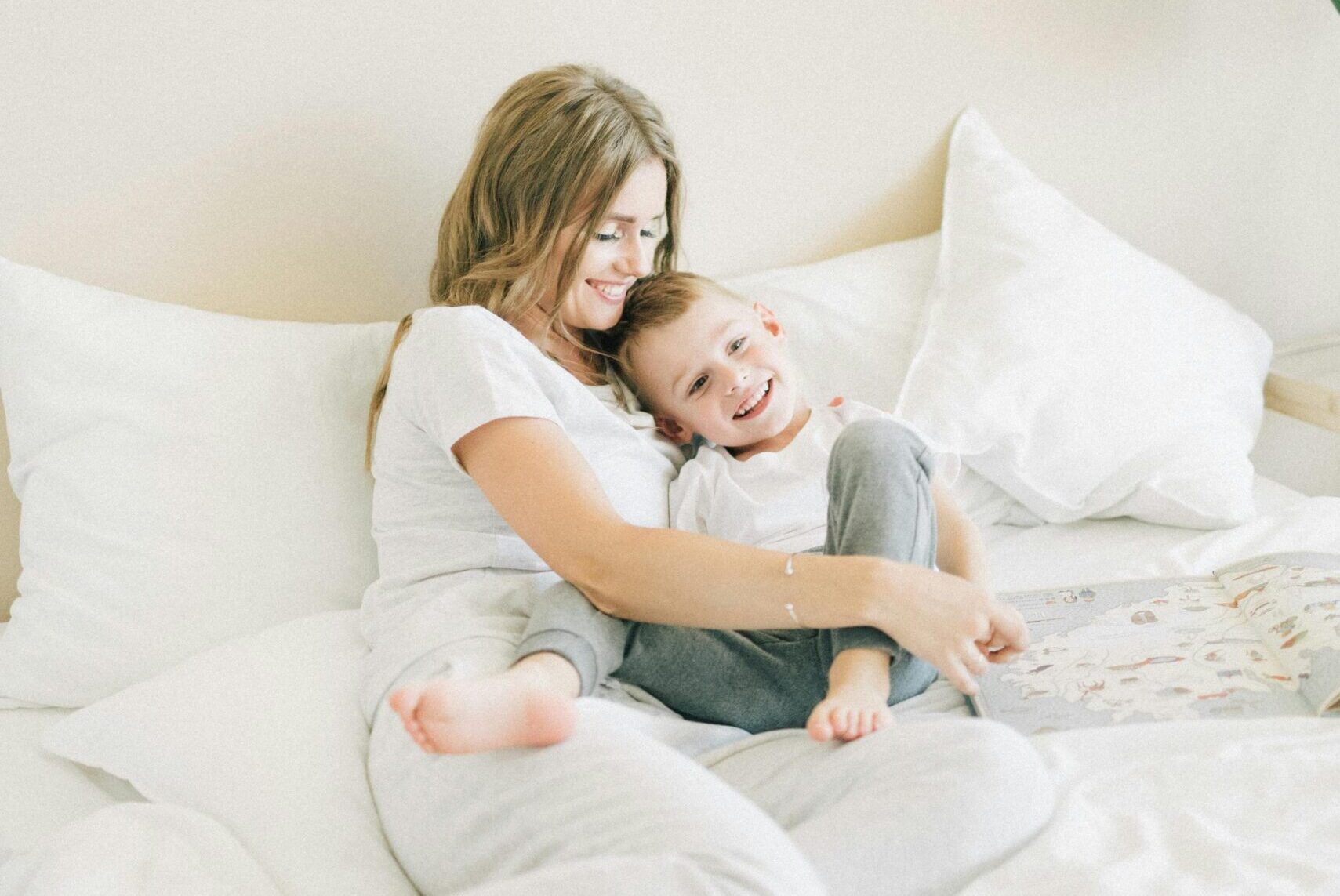 Child asking mother, "how long do tooth fillings last?" while lounging in bed